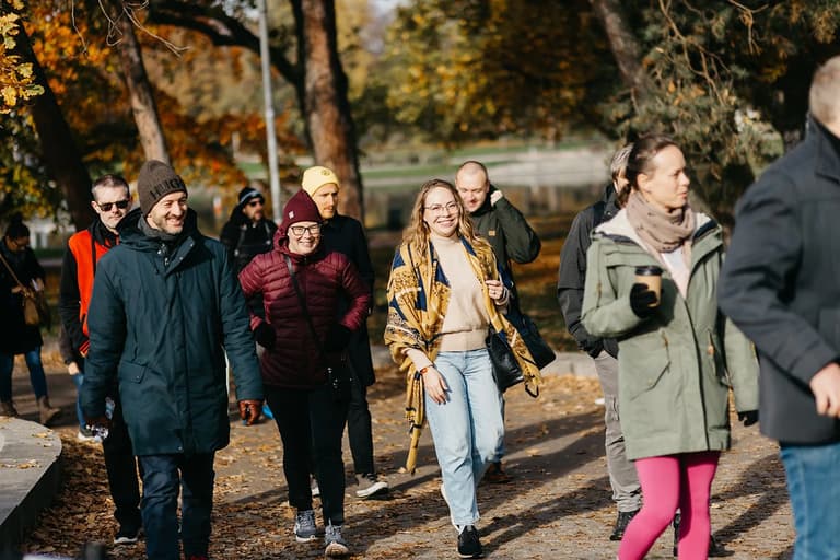 Conference guests on a group walk through an autumn park